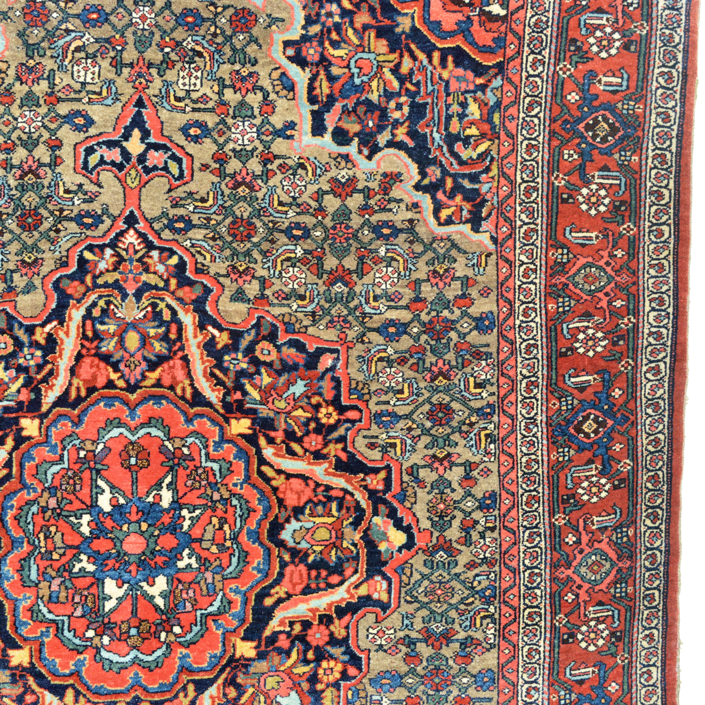 Medallion, field and border detail from an antique Bidjar rug. The camel field contains a navy blue and coral medallion and the field is decorated with a version of the "Herati" design. Navy blue corner spandrels and a red border frame the field. Northwest Persia, circa 1920.
