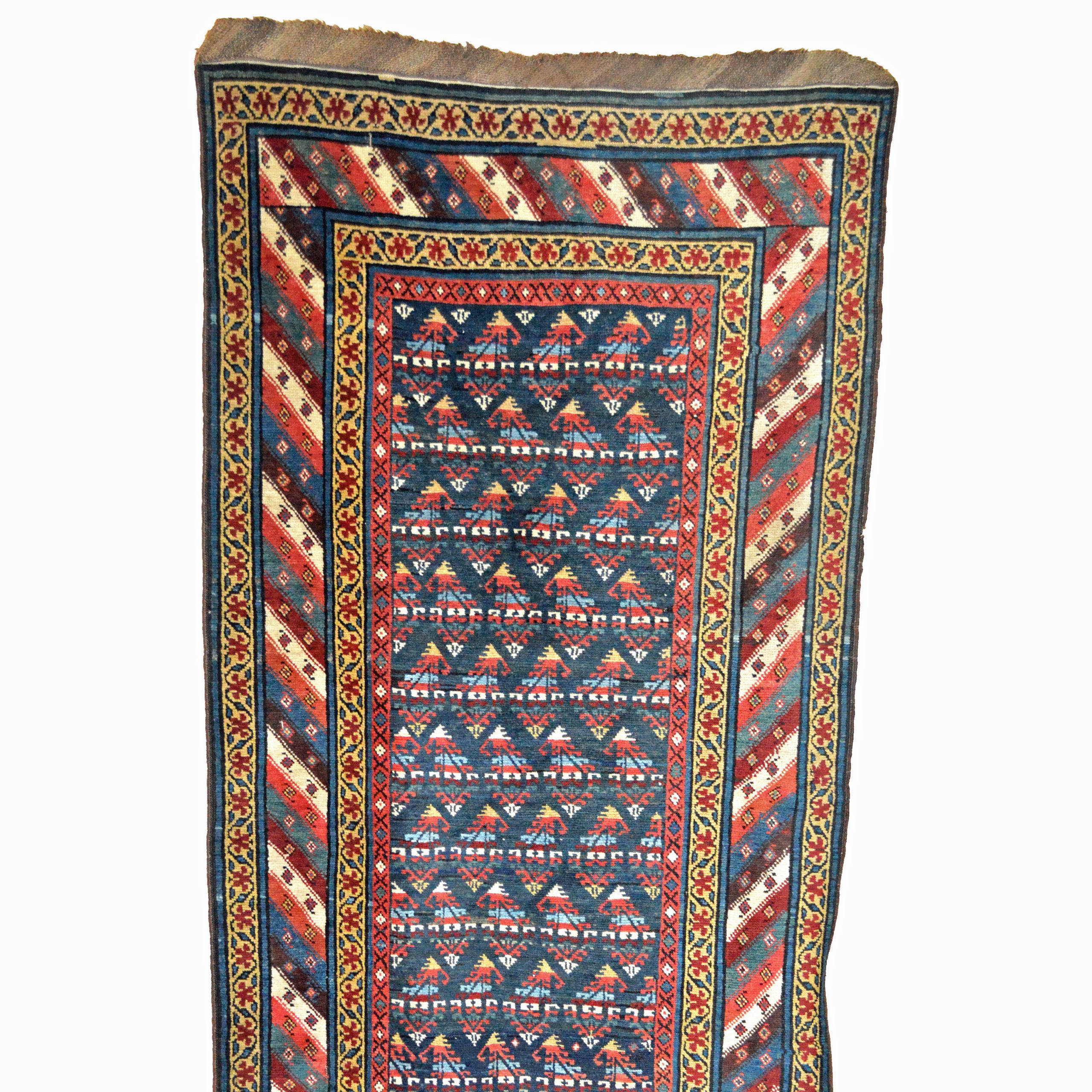 A beautifully colored antique northwest Persian runner rug with a navy field decorated with Boteh and framed by a multi-color diagonal stripe border, late 19th century.