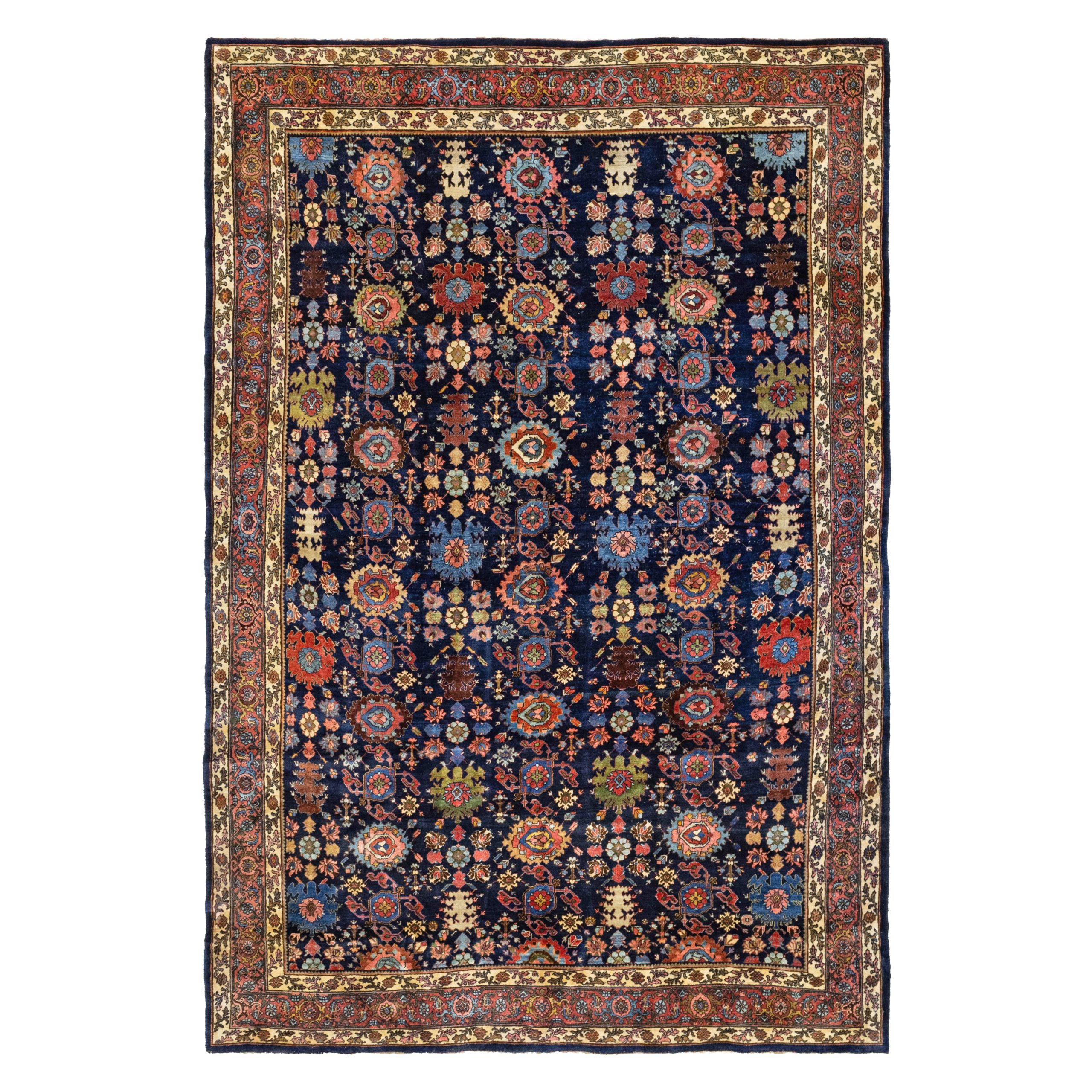An antique Bidjar carpet with a navy blue field that is decorated by the classic "Harshang" design of various palmettes and flowers. A light rose color border frames the field. Northwest Persia, circa 1900. Douglas Stock Gallery specializes in antique Persian Bidjar carpets and other types of antique Persian Kurdish rugs. Antique Bidjar carpets Boston,MA area New England, antique Bidjar rugs NYC by appointment, antique Bidjar rugs Washington, DC area by appointment