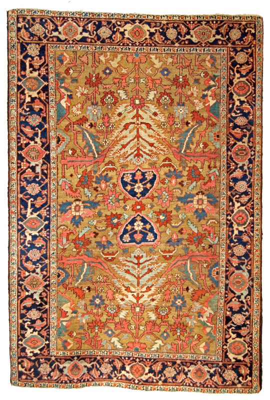 An antique northwest Persian Heriz rug of the age and caliber where examples are often referred to colloquially as antique "Serapi rugs". The yellow-camel field color is quite rare and beautiful and is decorated with various palmettes, leaves and flowers and framed by a navy blue "Turtle" design border. Douglas Stock Gallery specializes in antique Heriz, "Serapi" and Bakshaish rugs from the Heriz district in northwest Persia's Azerbaijan province.