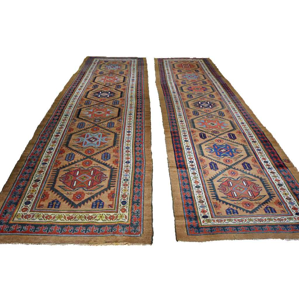 Pair of antique Persian Serab runners. The camel color field of each is decorated with a series of medallions and framed by a Reciprocal Trefoil border, northwest Persia, circa 1890 Douglas Stock Gallery.
