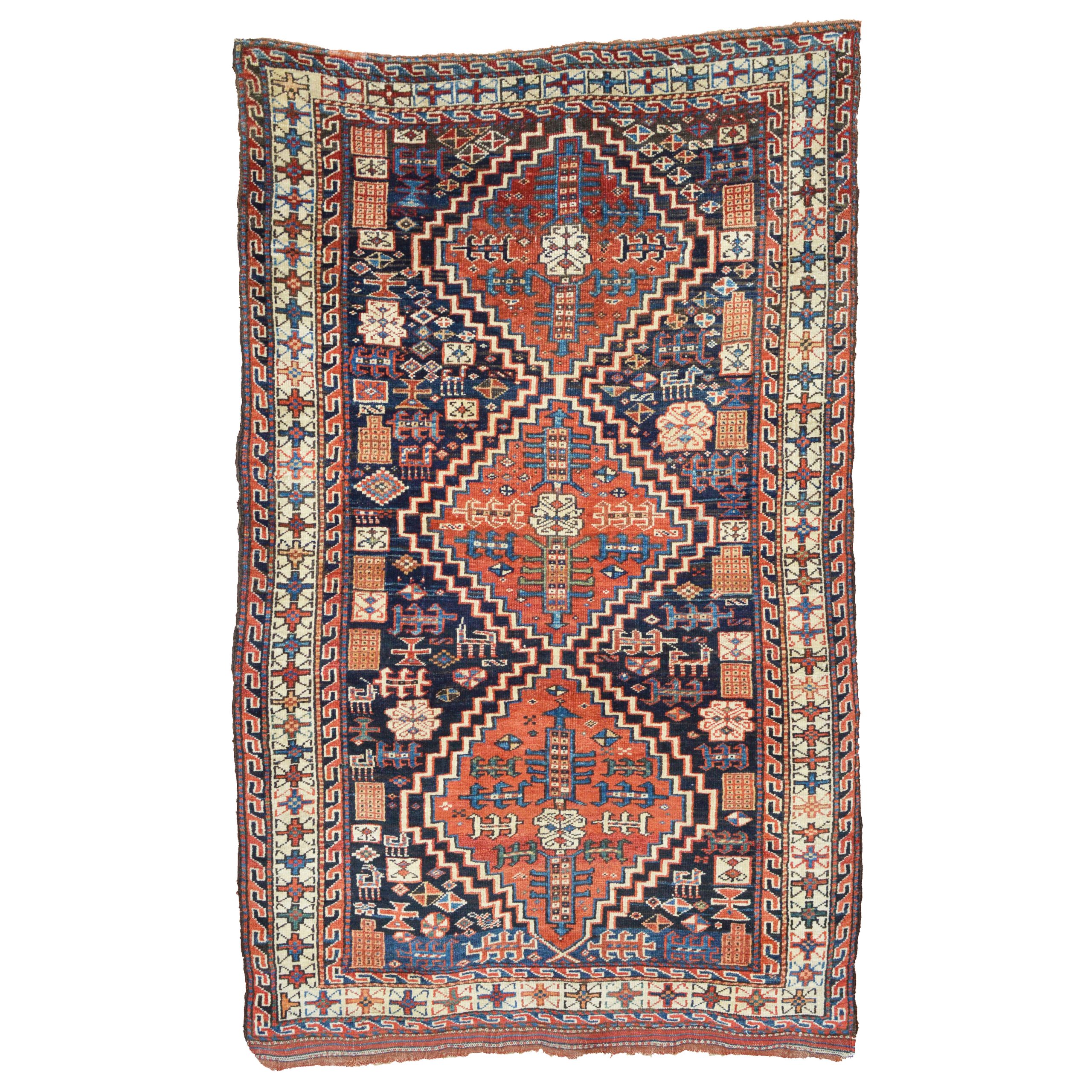 An antique Persian tribal rug with three terra cotta color medallions, stylized animals and geometric motifs on a navy blue field that is framed by an ivory border, possibly northwest Persia, circa 1900. Douglas Stock Gallery antique tribal rugs Boston,MA area New England, antique tribal rugs NYC by appointment, antique tribal rugs Washington,DC area by appointment