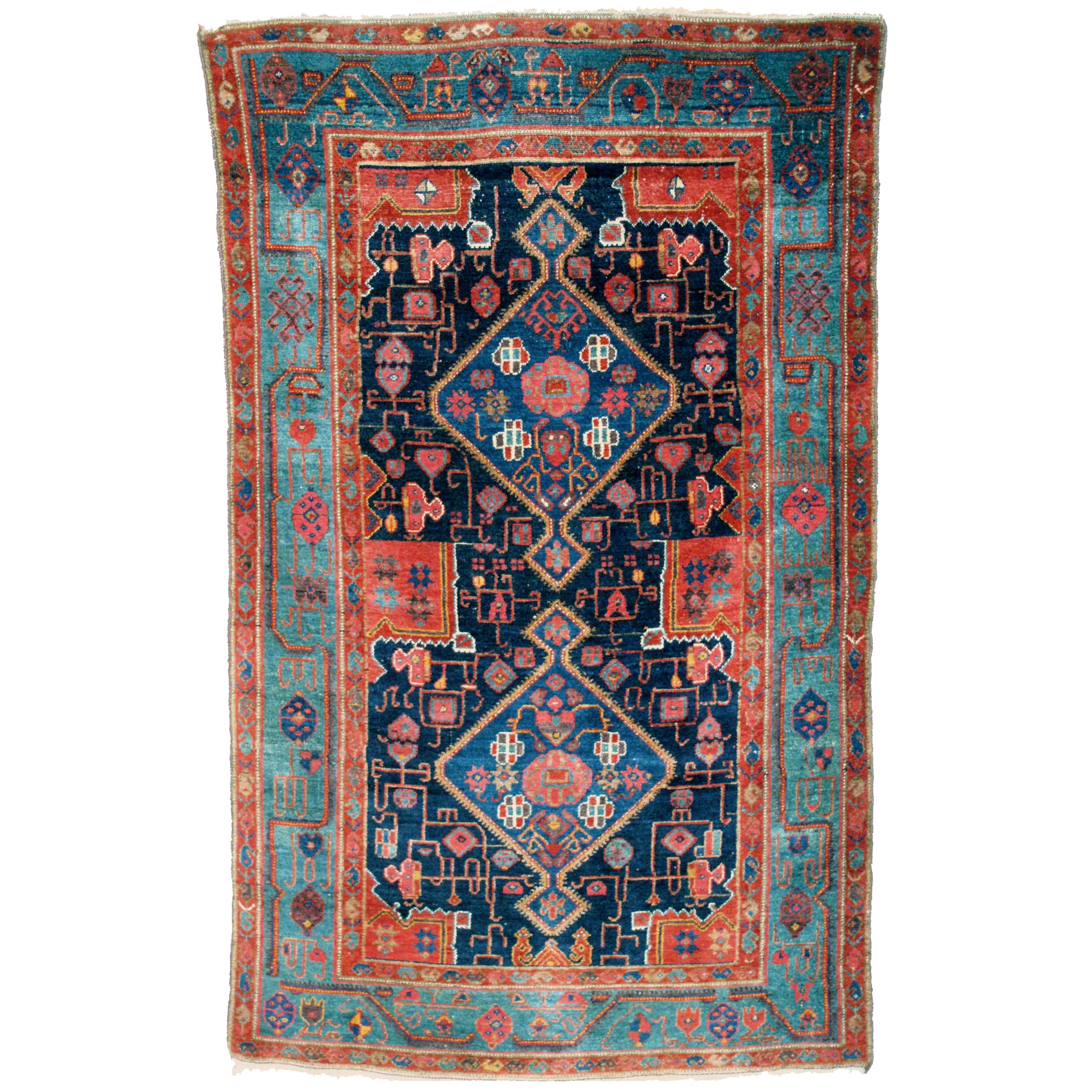 An antique Kurdish rug probably woven in the Kolyai area in west Persia, circa 1900. The navy blue field is decorated with two mid blue medallions with stylized flowers. A green borders frames the field. Douglas Stock Gallery Antique Oriental Rug Research Archives.